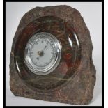 An early 20th century Art Deco carved Cornish Serpentine Marble Aneroid Barometer. Inset circular