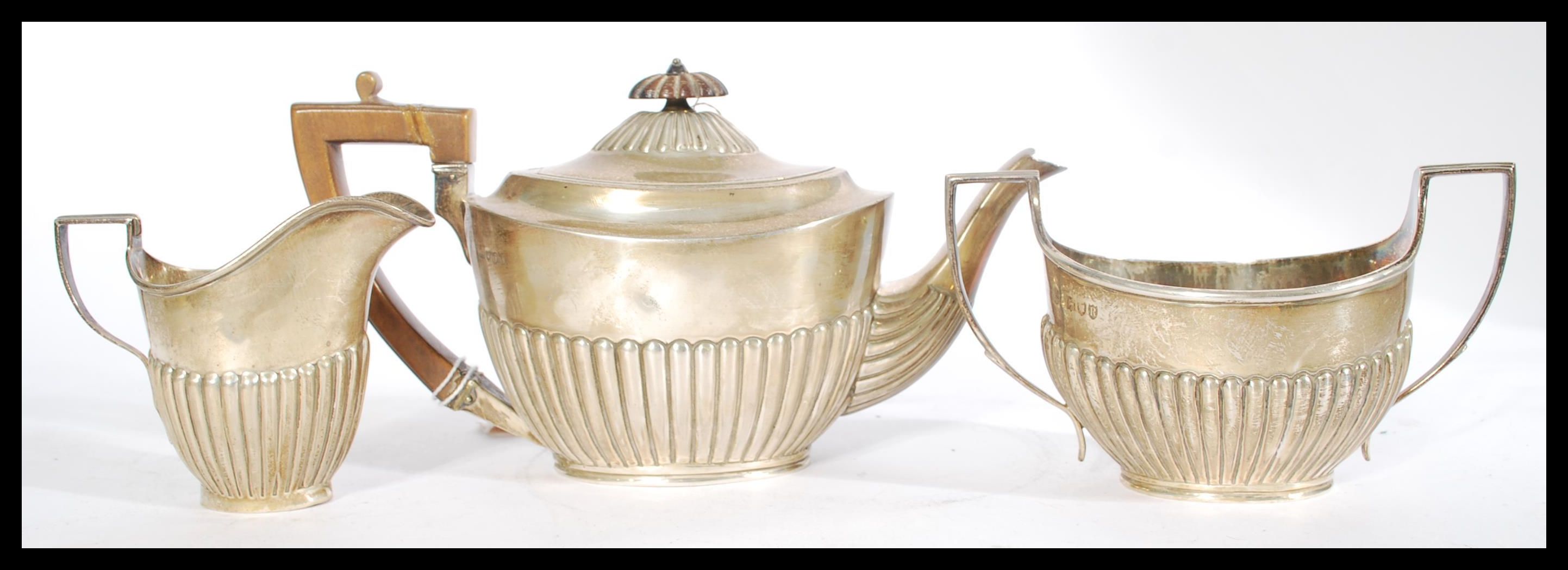 A silver hallmarked three piece boat shaped matched tea service having a part fluted gadrooned - Image 2 of 8