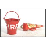 A vintage retro 20th century red painted metal fire bucket along with a mid century fire