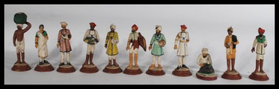 A collection of eleven early 20th Century Anglo - Indian hand painted terracotta figures of