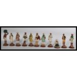 A collection of eleven early 20th Century Anglo - Indian hand painted terracotta figures of