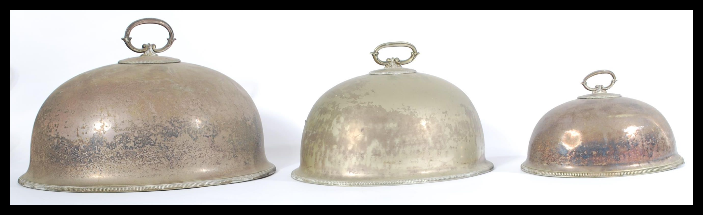 A set of 3 early 20th century silver plated meat covers. Each with banded edges of graduating size