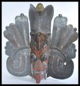 A vintage 20th Century carved African wooden ceremonial mask with original paint