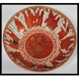 A 19th century Japanese Meiji period Satsuma ware bowl having ocher red hand painted decoration of