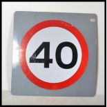 A motoring 40mph road speed sign having bold red numerals in circle on white ground. Perfect for a