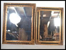 2 contemporary 20th century mirrors of matching form having ebonised and gilt embellished cushion