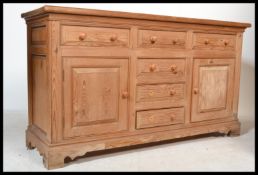 A good quality large antique style pine dresser base raised on bracket feet with a series of