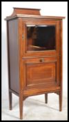An Edwardian mahogany inlaid music pedestal cabinet. Raised on squared legs with a glas door
