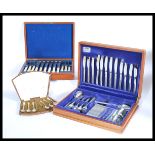 Two vintage 20th Century oak cased canteens of silver plated cutlery, one being a fish service.