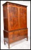 An antique style mahogany Regency revival linen press wardrobe. Raised on square tapered legs with