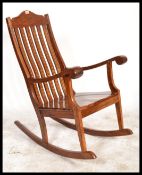 A 20th Century Hardwood antique style rocking chair with brass inlaid decoration
