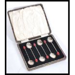 A set of 6 silver hallmarked coffee bean spoons with red bean handles. Complete in the