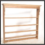 A 19th century Victorian hanging pine wall shelf / plate rack having multiple shelves with flared