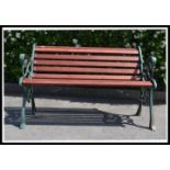 A very heavy 20th century cast metal garden bench, recently having new wooden slats added and a