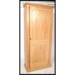 A Victorian large 19th century country pine housekeepers cupboard raised on a plinth base having a