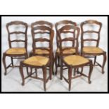 A set of 6 French provincial oak ladderback dining