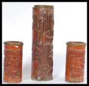 A group of three early 20th Century Chinese brush pots, carved from bamboo with panels depicting