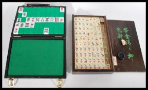 Two Chinese Mahjong sets one being an early 20th century wooden cased example and the other later in