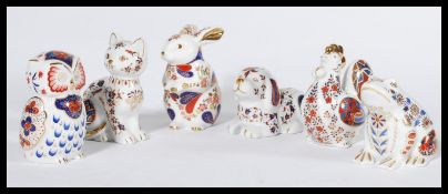 A collection of six imari pattern ceramic paperweights in the form of animals to include dog , cat ,