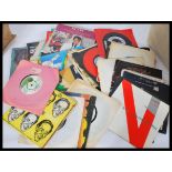 A large collection of 7" vinyl record singles and EP ( Extended Play ) dating from the 1960's