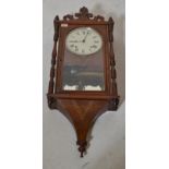 A 19th century Victorian mahogany and boxwood inlay wall clock having hard carved pediment with