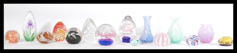 A collection of studio art glass paperweights along with three Caithness vases. Matts Jonasson ,