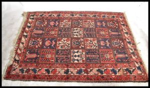 A stunning early 20th Century Persian / Islamic floor rug / carpet having a large central panel