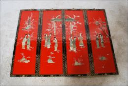 A set of 4 mid century Japanese hanging panels, each with red lacquered centres with geisha, temple,