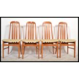 A 1970's retro set of teak wood railed back dining chairs having pad seats with shaped legs united