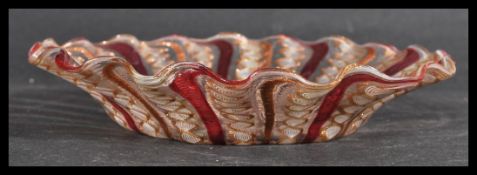 A 19th century Venetian glass bowl of scalloped form having hand painted red lines with gilt swirl