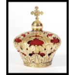 A brass pincushion in the form of a crown with acanthus leaf decoration.