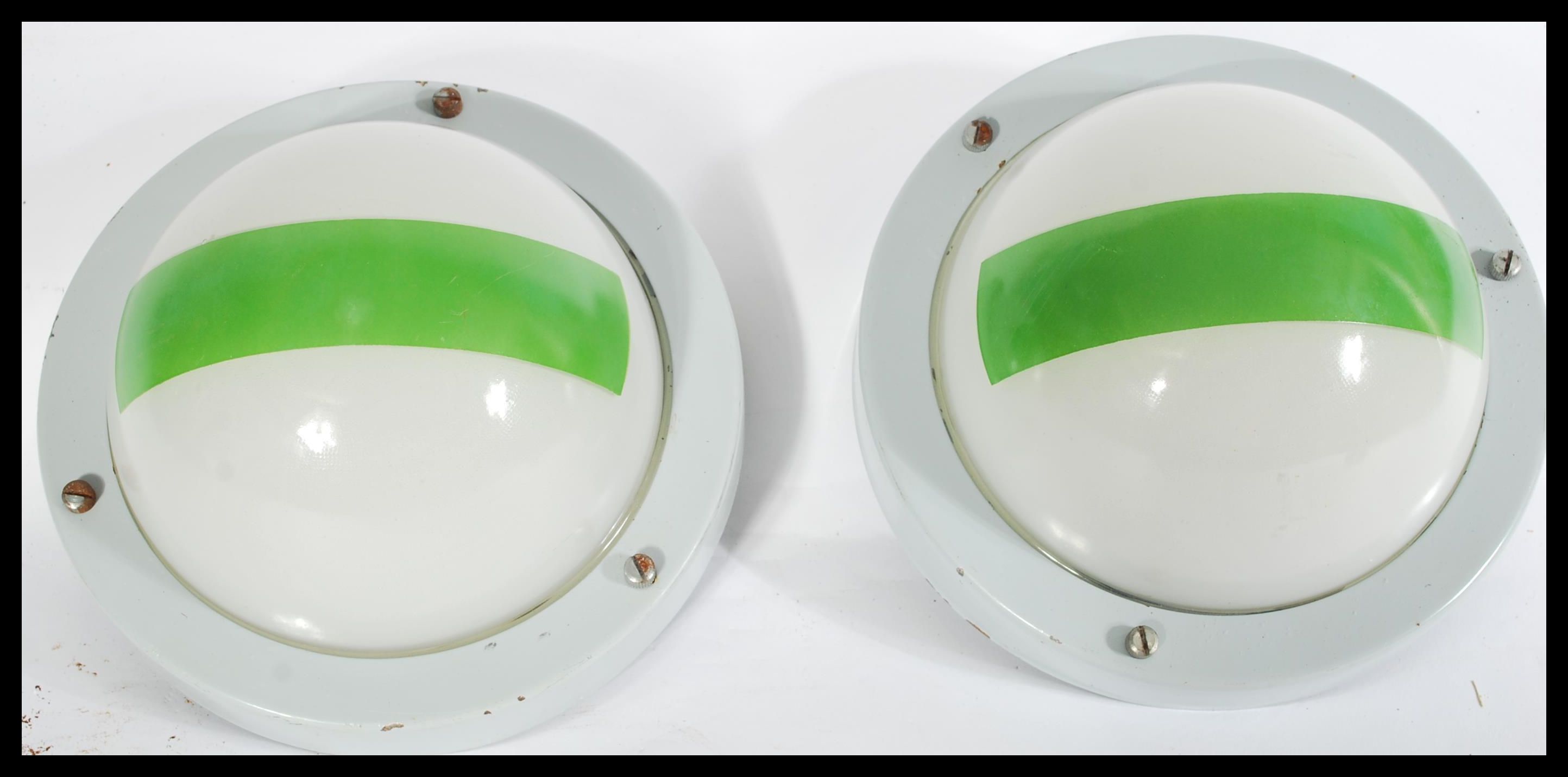 A pair of vintage mid 20th Century bomb blast proof circular bulkhead lights, possibly of Naval