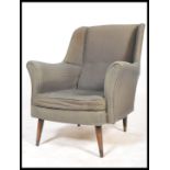 A mid century armchair in the manner of Robin Day for Hille Furniture. The chair with tapering