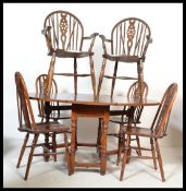 A Jaycee / Old Charm type oak drop leaf dining table raised on turned legs having a set of 6