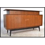 A 1970's G-Plan Tola wood ' Librenza ' pattern sideboard with ebonised tapering legs, wide body with