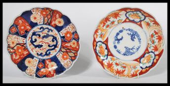 Two 19th century Japanese Imari charger plates of scalloped form , one having a central cartouche