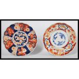 Two 19th century Japanese Imari charger plates of scalloped form , one having a central cartouche