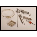 A group of sterling silver jewellery to include a Celtic knot bangle , horse shoe and riding crop