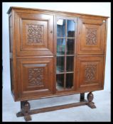 A large early 20th century carved oak bookcase cab