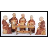 A group of five vintage 20th Century ceramic  decanters modelled as monks, sat around a miniature