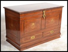 A 20th Century hardwood brass inlaid sideboard, having two short drawers over cupboards, with