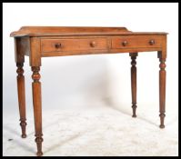 A 19th century Victorian mahogany writing table desk being gallery backed. Raised on turned column