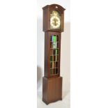 An antique style Tempus Fugit grandmother clock. Oak veneer trunk with glass hood housing silvered