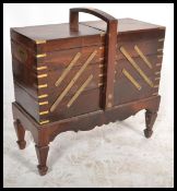 A 20th Century hardwood, brass inlaid concertina work / sewing box, having multiple sections with