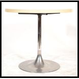 A retro mid century tulip dining table in the manner of Eeero Saarinen.  Polished steel tulip base