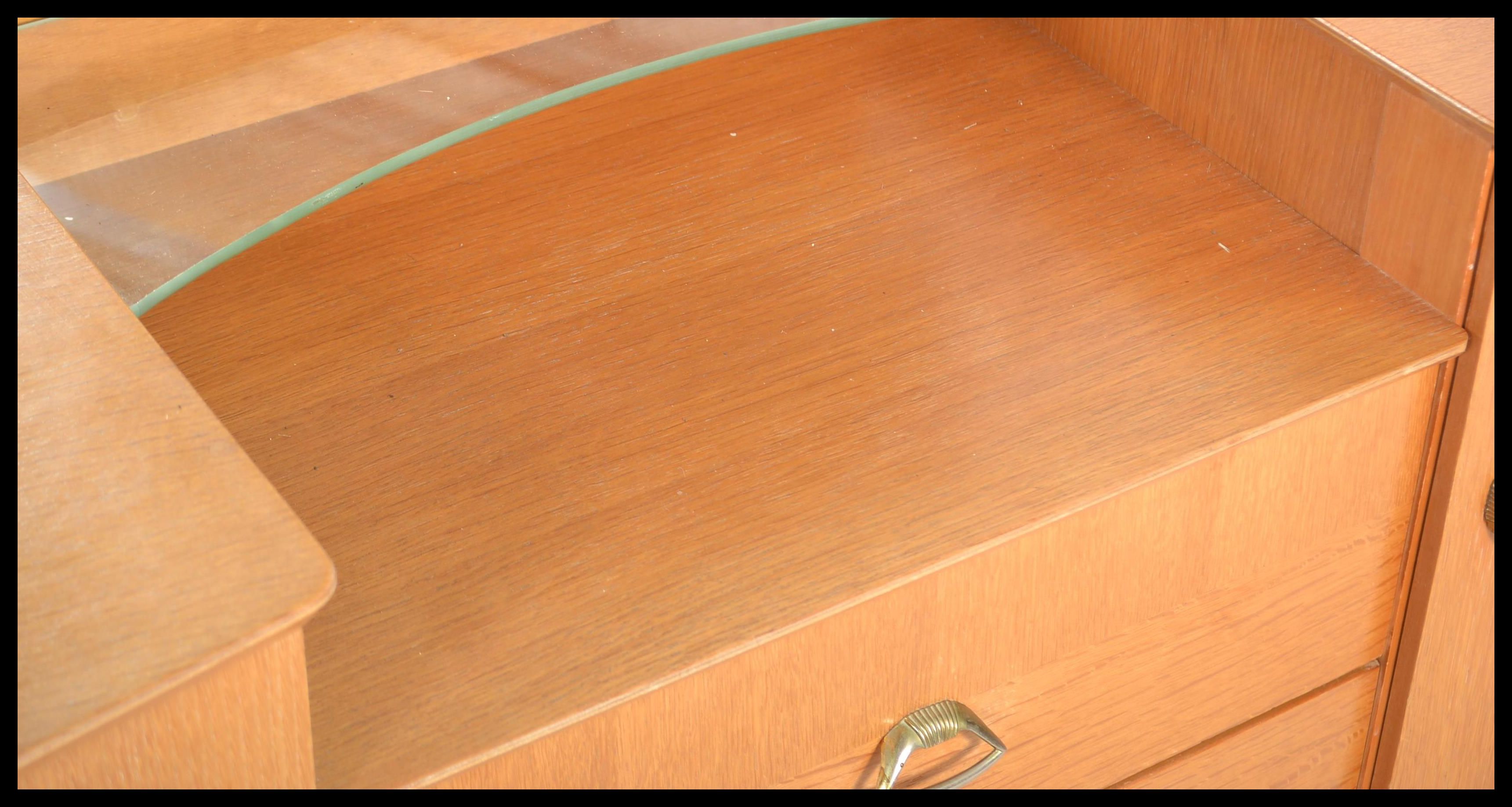 A 1960's retro oak drop centre dressing table being raised on tapering legs with a large mirror of - Image 3 of 6