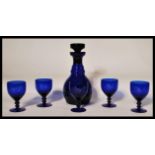 A 20th Century blue glass decanter and stopper in the manner of Bristol Blue Glass together with
