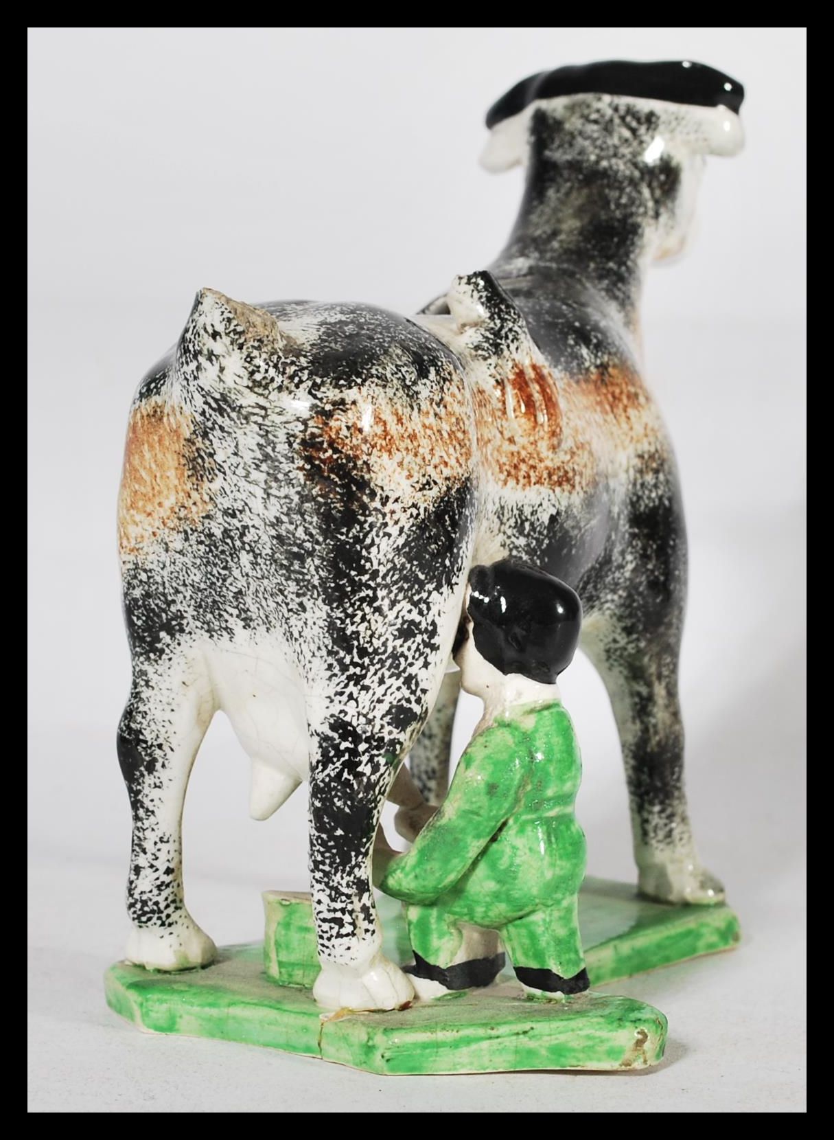 An early C19th Staffordshire pearlware cow creamer, shaped base with milk maid milking into a - Image 3 of 5