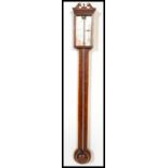 A 19th century Georgian stick barometer. The mercury barometer with mahogany backing having