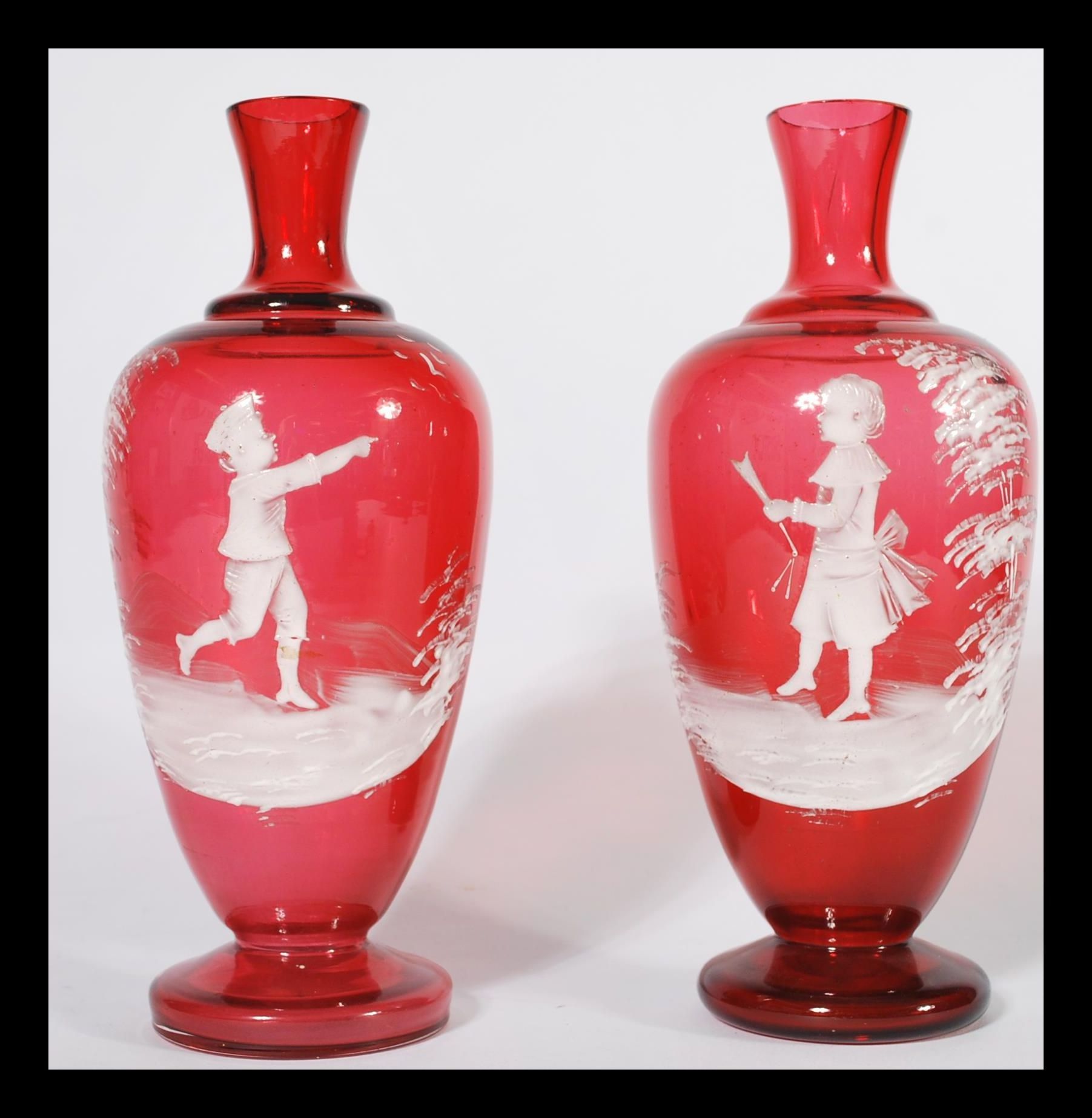 A pair of Mary Gregory style cranberry glass vases